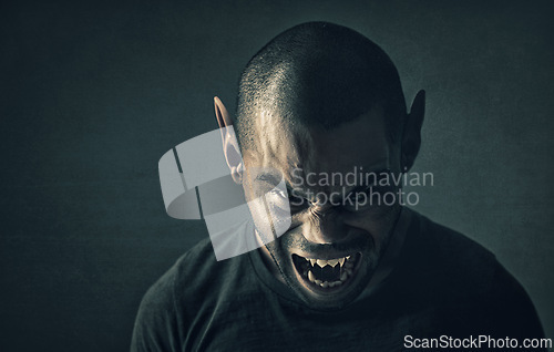 Image of Monster, man and face with horror in studio for fantasy, demon and angry vampire with fangs, scary and terror. Werewolf, devil and creepy creature with shouting, rage and surreal on black background