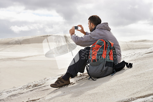 Image of Phone, photography or man in a desert for travel, adventure or profile picture in nature. Smartphone, app and social media nomad influencer with photoshoot of sand dunes scenery on journey in Egypt