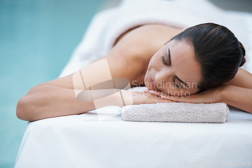 Image of Luxury, spa and woman relax for massage on table in hotel, calm and care for body in vacation. Holiday, outdoor and female person on break for weekend, accommodation and lodge for skincare in resort