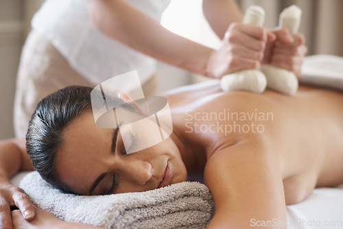 Image of Relax, herbal compress and massage of woman at spa for skincare, peace or calm at luxury resort. Beauty, therapy and masseuse with bag at salon for body treatment, health or hands of person on back