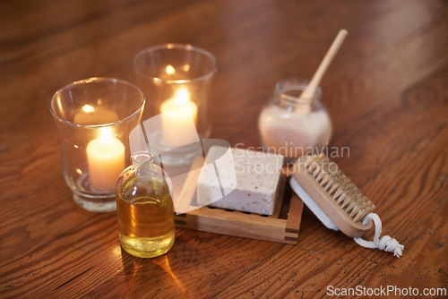 Image of Spa, aromatherapy and candles with oil, brush for zen, calm or peace to relax for health or natural healing. Incense, wellness or flame light for wellbeing, holistic massage or hospitality background