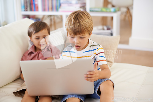 Image of Laptop, love and kid siblings on a sofa with cartoon, film or streaming movie at home. Computer, e learning or children in a living room for google it, search or gaming app, show or Netflix and chill