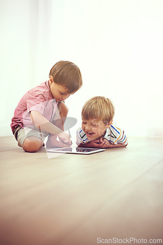 Image of Tablet, children and siblings on a floor with cartoon, gaming or streaming movie at home. Digital, learning and boy kids in house for google it, search or ebook storytelling, app or Netflix and chill