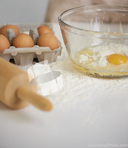 Image of Baking, kitchen and eggs in bowl with flour for cake, bread and pastry preparation in home. Culinary, bakery and closeup of ingredients, wheat and utensils for pizza, dough and food on counter