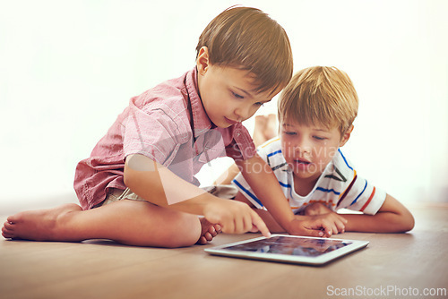 Image of Siblings, children and tablet on a floor with cartoon, gaming or streaming movie at home. Digital, learning and boy kids in house for google it, search or ebook storytelling, app or netflix and chill