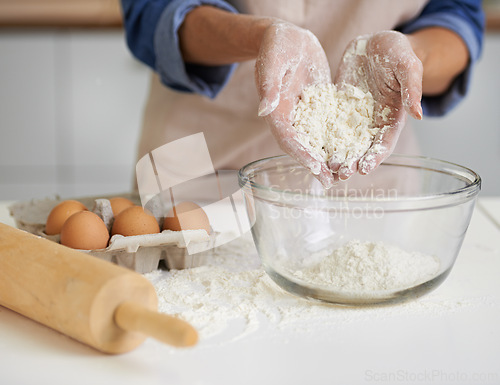 Image of Hands, person and flour with eggs, kitchen and rolling pin for baking. Baker, dough and food with countertop, apron and mixing for recipe preparation and recreation or hobby at home or house