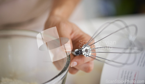 Image of Hands, person and whisk with cookbook, kitchen and bowl for baking. Baker, muffin or pastry and food with countertop, apron and cooking for recipe preparation and recreation or hobby at home or house