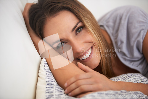 Image of Woman, portrait and relax with happiness and calm, comfort with positive mood for leisure on couch. Rest, lying down with pillow and smile for stress relief, break on day off or weekend at home