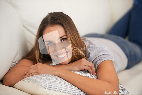 Image of Happy woman, portrait and relax on sofa in living room, calm and comfort with positive mood for leisure. Rest, lying down with pillow and smile for stress relief, break on day off or weekend at home