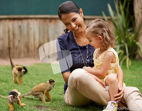 Image of Animal, mother and young girl with monkey for wildlife rescue, outdoor activity or interactive experience in nature. Conservation, zoo and happy family for bonding, holiday and travel at sanctuary