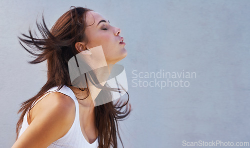 Image of Woman, hair or shake as hairdressing, haircare or keratin for texture, growth or scalp on mockup. Wind, long or natural style as grooming in hairstyle, shine or volume in studio on grey background