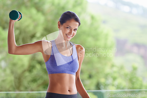 Image of Happy woman, portrait and weightlifting with dumbbells for workout, exercise or muscle gain on balcony. Young female person with smile and small barbell for fitness or outdoor training on terrace