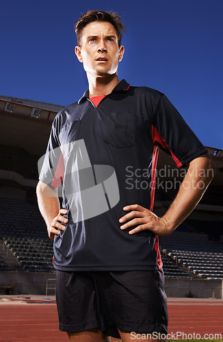 Image of Man, sports and confident soccer player in stadium, athlete and competitive for match or game. Male person, serious face and determined for competition, outdoors and focus for football challenge
