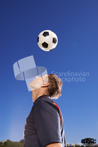 Image of Football, bounce and head with man, training and technique with competition and exercise. Person, blue sky and player with practice for a game or athlete with skills and sports with fitness or soccer