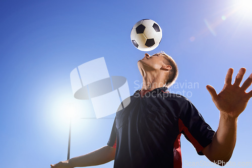 Image of Football, bounce and head with man, game and training with competition, sunshine and exercise. Blue sky, lens flare and player with practice or athlete with skills or technique with fitness or soccer