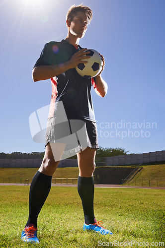 Image of Man, fitness and confident soccer player on field, athlete and competitive for match or game. Male person, serious and determined for competition, outdoors and ready for football challenge or sports