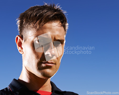 Image of Portrait, man and athlete serious outdoor, sky background for fresh air with football player at stadium. Determined face, confident and pride in headshot with professional sportsman at training