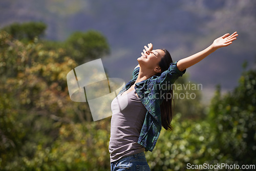 Image of Freedom, joy and relax for woman in outdoor, garden or forest for bliss, satisfaction and fulfillment. Young person, smile with arm in air for optimism, happiness and excited in environment on mockup