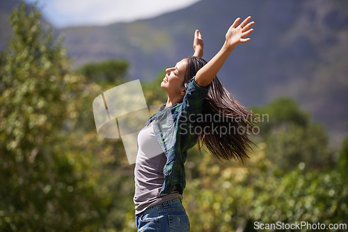 Image of Freedom, wellness and hands raised with young woman relax in garden for enthusiasm or inspiration. Nature, park and smile with happy person outdoor at park in summer for energy or excitement