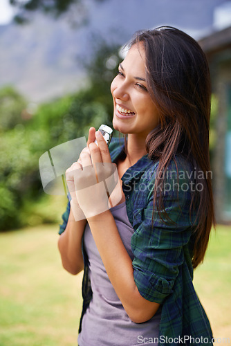 Image of Phone, smile and summer with woman in garden of home for communication, landscaping or memory. Happy, funny and laughing with cheerful young person on grass or lawn of backyard for carefree weekend