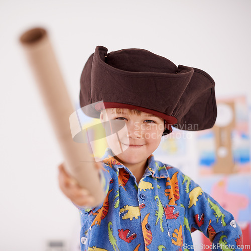 Image of Child, portrait or costume as pirate to play in fantasy in his bedroom with telescope toy or smile. Kid sailor, proud captain or happy boy in a game with pyjamas, hat or creative monocule to sail