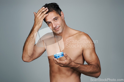 Image of Haircare, hairstyle and man in studio with gel for growth, cosmetics and cosmetology in portrait. Mature person, beauty and bare male with confidence for hair routine or treatment in gray background