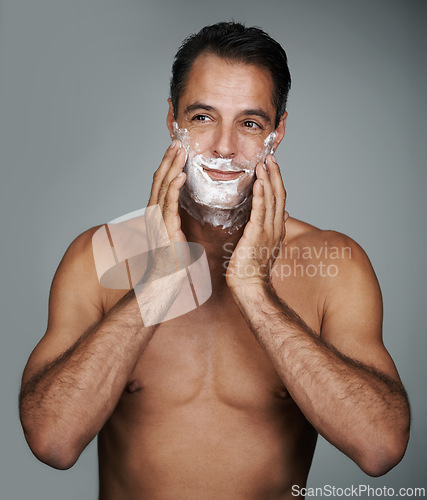 Image of Man, shaving and foam for beard skincare or after shave with hair removal product, transformation or grey background. Male person, hands and studio wellness or face application, grooming or mockup