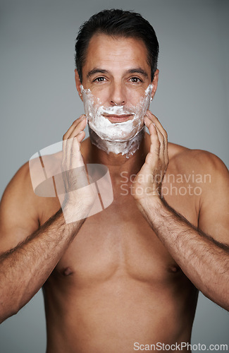 Image of Man, portrait and shaving cream skincare on beard or after shave with hair removal product, transformation or grey background. Male person, hands and studio or face application, grooming or mockup