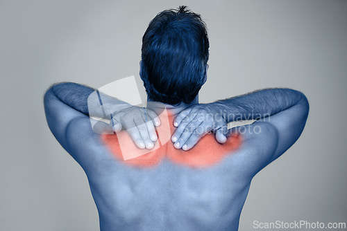 Image of Studio, man and hands for shoulder pain or tension with muscle inflammation, discomfort and sprain of stress or strain. Red glow, back view and person with ache, injury and bruise on grey background