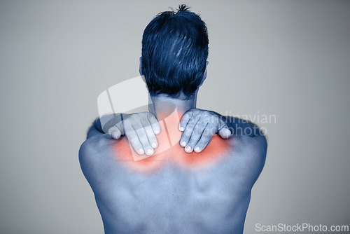 Image of Studio, man and hands for muscle or shoulder pain with tension or inflammation with discomfort, sprain and stress or strain. Red glow, back view and person with body ache or injury on grey background