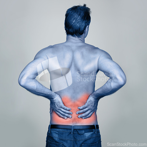 Image of Medical, back pain and man with injury in studio with inflammation, discomfort or muscle sprain. Red glow, shirtless and person with healthcare emergency, ache or strain isolated by gray background.