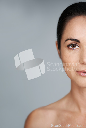 Image of Woman, studio and portrait with closeup, skin and care for treatment and proud. Model, cosmetics and natural with lip gloss, glow and aesthetic for antiaging confidence isolated on grey background