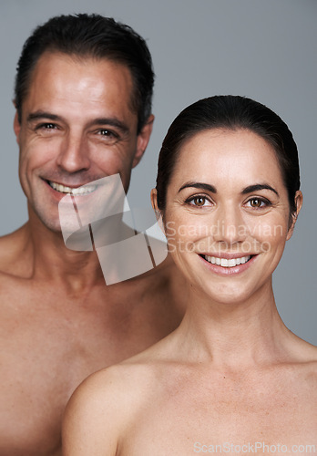 Image of Couple, portrait and skincare in studio, beauty and collagen cosmetics for anti aging. Mature people, facial treatment and dermatology for health on gray background, smile and together for wellness