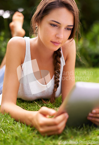 Image of Backyard, grass and woman relax with tablet, outdoor and garden in home for peace with technology. Summer, nature and girl online with connection to internet to read ebook on app for happiness