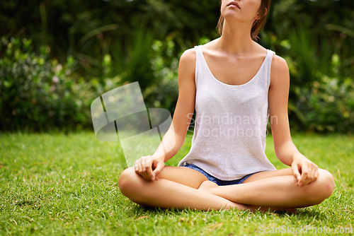 Image of Meditation, yoga and woman on grass, lawn and garden outdoor for wellness, peace and to relax in nature. Female person, young lady and gen z girl in lotus position by trees, plants and environment