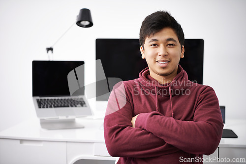 Image of Laptop, portrait and smile of man for software in office with information technology for cybersecurity. Coder, programmer and male person with arms crossed in workplace with monitor of computer