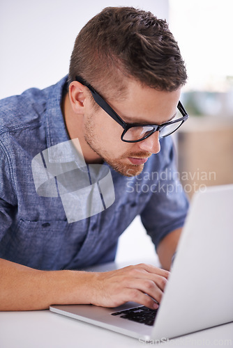 Image of University, glasses and man with laptop for research, study or elearning with education, knowledge and opportunity. Computer, reading and college student writing report for online course at desk.
