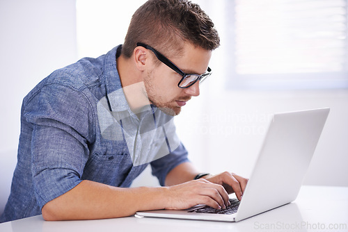 Image of University, elearning and man with laptop for research, study and typing for education, knowledge and opportunity. Computer, reading and college student writing report for online course with glasses.