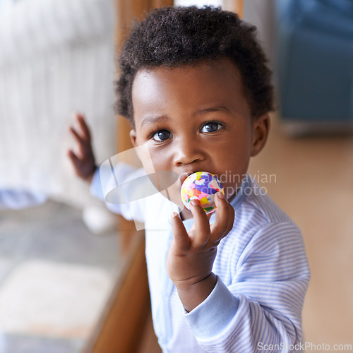 Image of Portrait, baby or toy in play, coordination or growth as learning, game or progress in Jamaica. Black boy, child or ball in mouth as healthy, motor skill or fun in curious, cognitive or sensory
