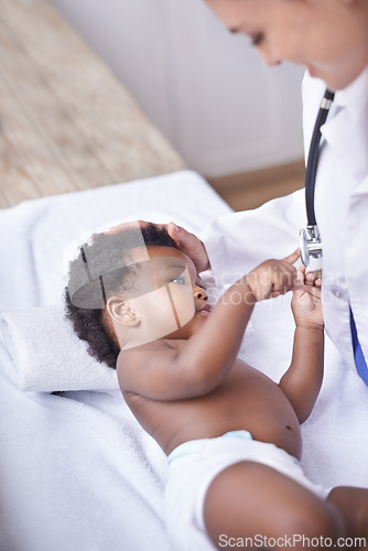Image of Baby, pediatrician and healthcare consultation with stethoscope as childhood development, examination or ill. Patient, kid and doctor support on hospital bed in Kenya for diagnosis, flu or wellness