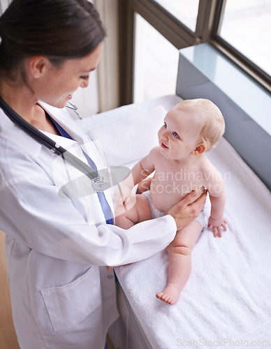 Image of Healthcare, pediatrician and woman with baby, boy and checkup with wellness and doctor in a clinic. Medical, cheerful professional or employee with smile and happy infant with appointment or medicare