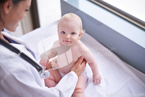 Image of Clinic, pediatrician and woman with baby, medical and checkup with wellness, consultation and doctor. Hospital, professional and employee with healthcare and infant with appointment and medicare