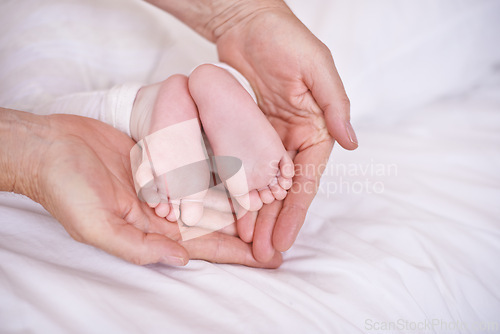 Image of Baby, feet and hands for childcare on bed or development with parenting trust with support, love or connection. Kid, foot and fingers in palm for wellness bonding in apartment, protection or security