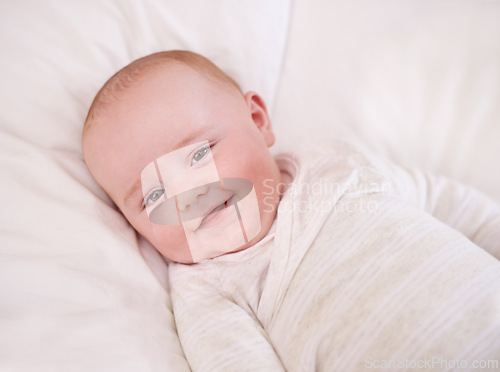 Image of Baby, portrait and smile on bed for relax comfort in family home for childhood development for growth, morning or care. Kid, boy and face on linen bedding in apartment with happiness, love or calm