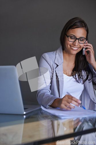 Image of Phone call, laptop and woman writing notes in office for finance research with budget project. Smile, technology and professional financial advisor on mobile discussion with computer in workplace.