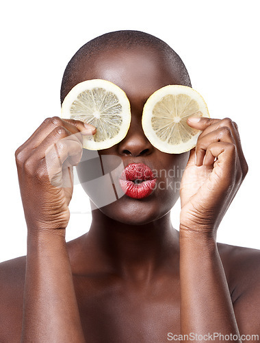 Image of Black woman, kiss and lemon skincare in studio for organic dermatology routine, youth or wellness. White background, face and African model with facial fruit, diet food and eyes product for beauty