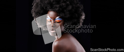 Image of African woman, makeup and eyeshadow with beauty, skin and creative with studio and color. Model, closeup and face paint for artistic, contrast and aesthetic for glamour isolated on black background