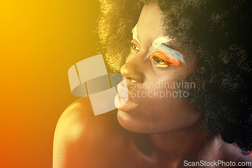 Image of Beauty, eyeshadow and studio for black woman person, art and concept on dark background. Afro, colourful and makeup on face of Nigerian female model, flare and afro for cosmetic and creative concept