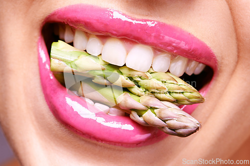 Image of Woman, lipstick and closeup of vegetable in mouth for beauty, nutrition and healthy with vegan cosmetic product. Cruelty free makeup, cosmetology and asparagus, pink lip gloss for aesthetic or art