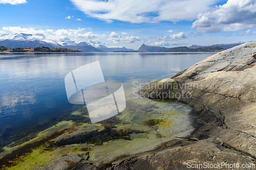 Image of Tranquil morning by the crystal-clear sea with snow-capped mount